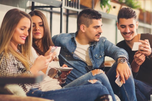Friends laughing together outdoors in natural light